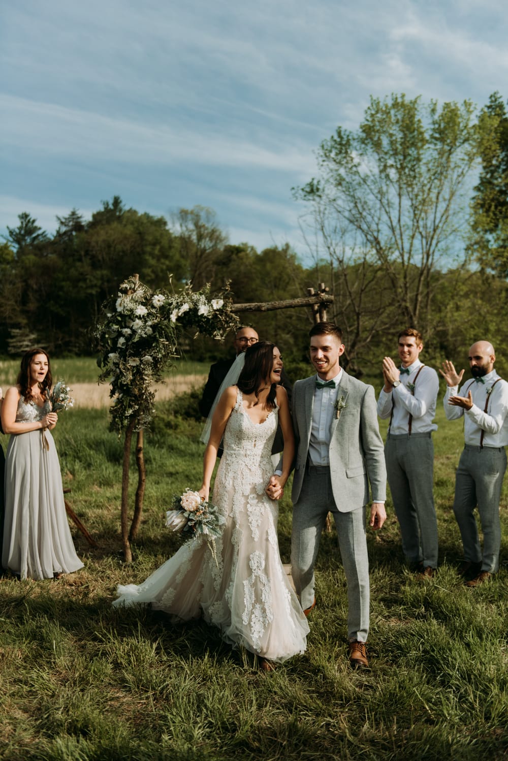 Bride and groom walking back down the aisle after their cozy and emotional ceremony in Bloomington, Indiana.