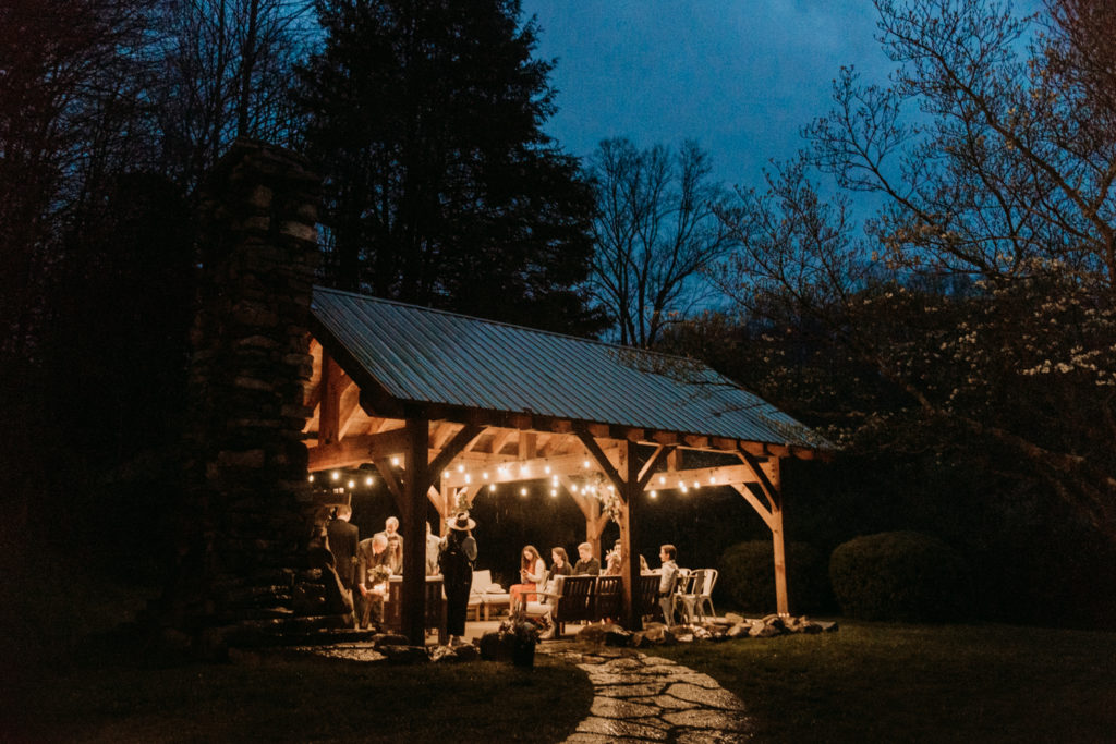 Intimate wedding reception on a covered patio outside an Airbnb with family and friends