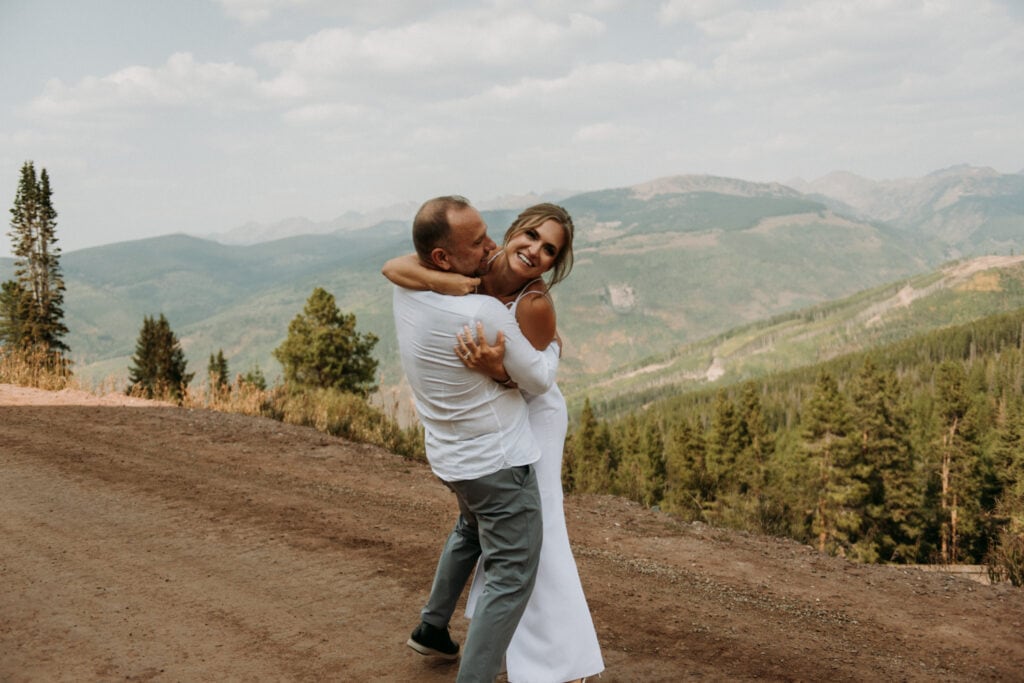 Wedding couple dancing around at their Airbnb wedding in Vail Colorado