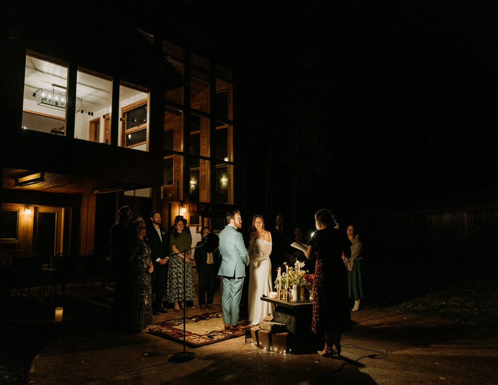 A nighttime wedding ceremony outside of an Airbnb in Ouray
