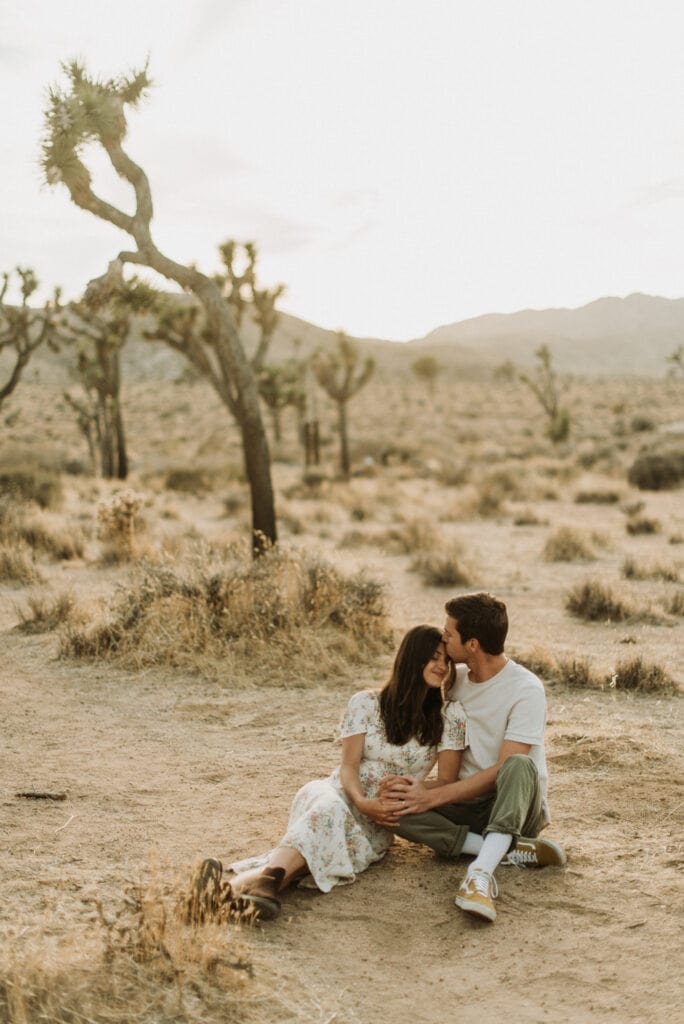 Snuggles in the desert during an anniversary session in Joshua Tree california. Joshua tree national park engagement photos at cap rock