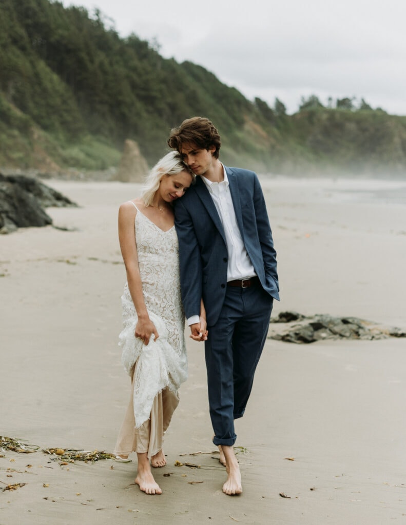 couple walking around the beach for their mexico elopement