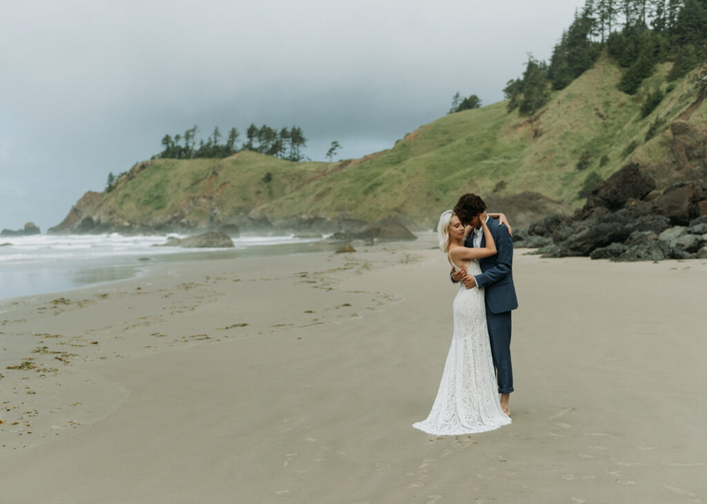 couple embracing on the beach in mexico during their elopement