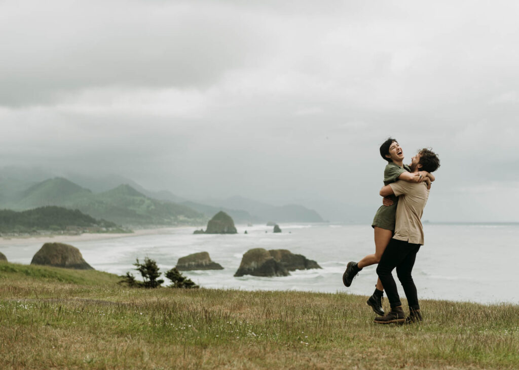 Adventurous couples session on a cliffside in oregon at ecola state park