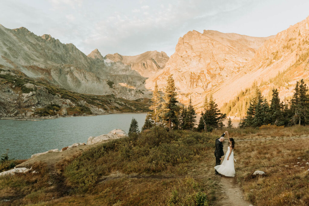 a couple dancing in the meadow on their elopement day at lake isabelle in colorado