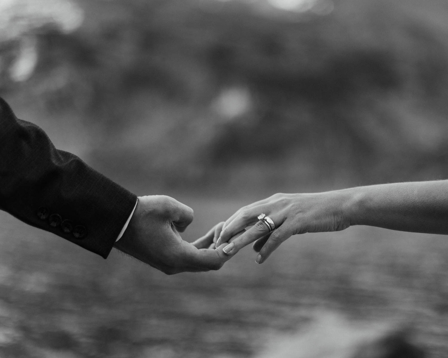 a couple holding hands with their new wedding rings