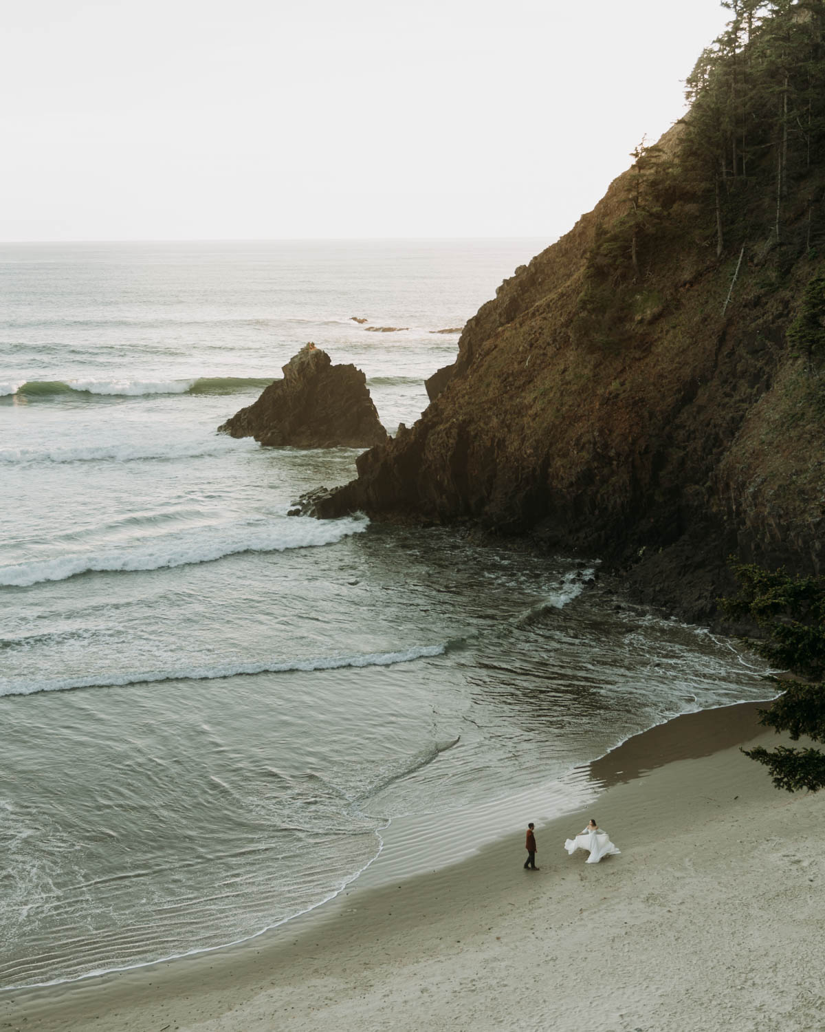 Denisse & Brand dancing on the beach at their adventure elopement at Indian Beach in Ecola State Park Oregon