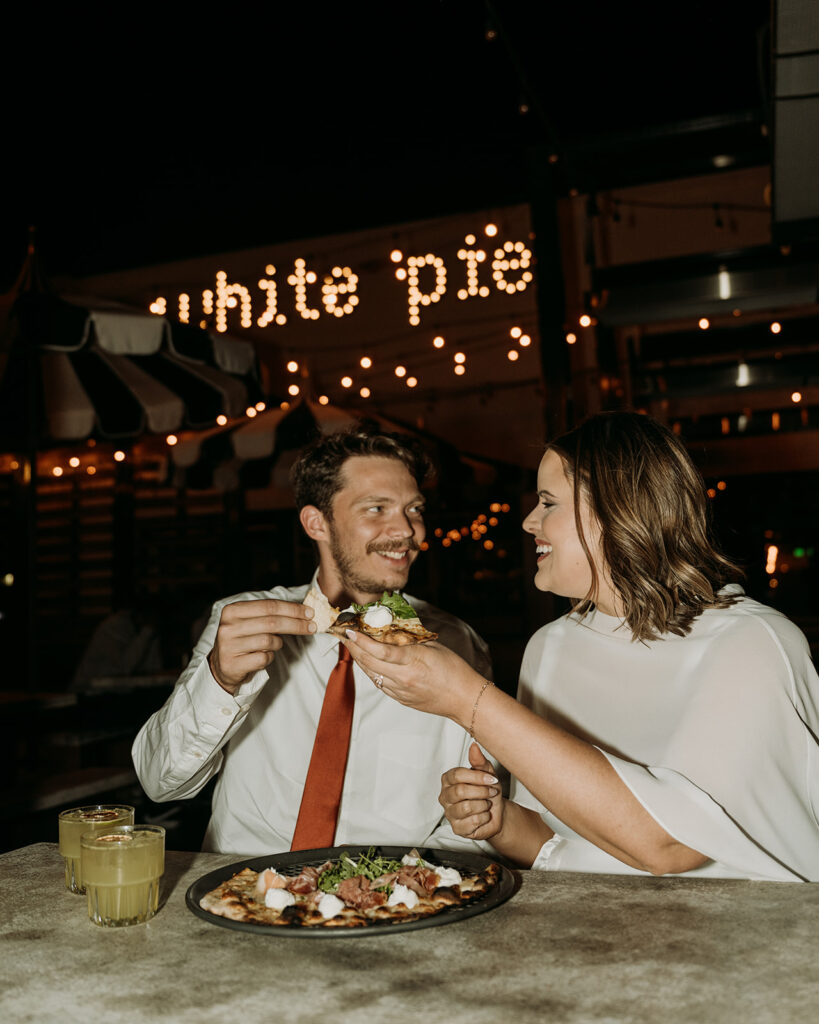A couple shares pizza at White Pie during their Colorado Springs elopement