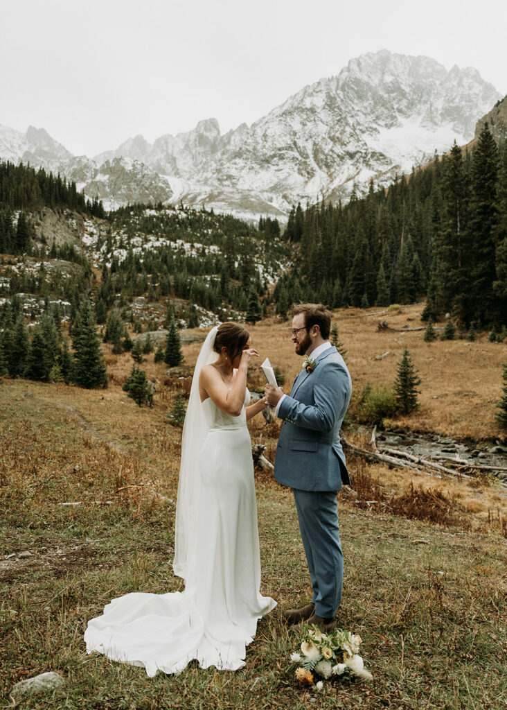 A couple shares their emotional vows during their ceremony at their fall hiking elopement in the San Juan Mountains of Colorado