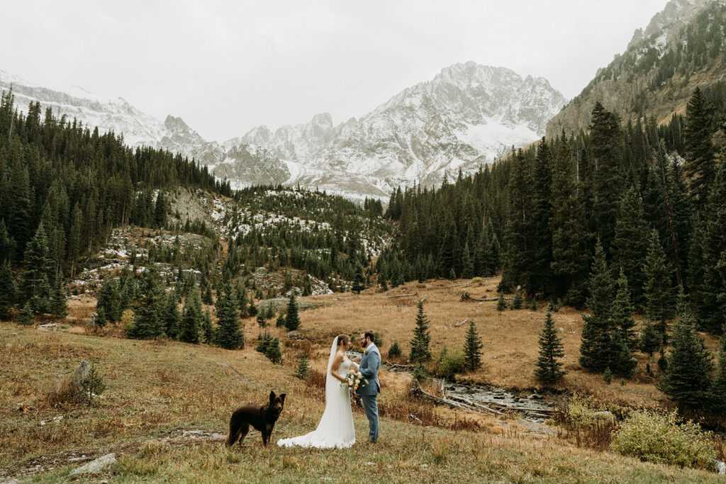 A couple shares their vows during their ceremony at their fall hiking elopement in the San Juan Mountains of Colorado