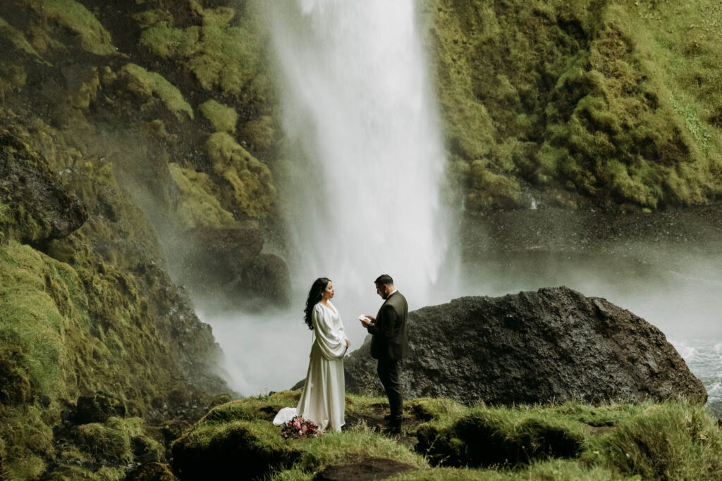 Couple sharing emotional vows during their iceland elopement at Kvernufoss waterfall.