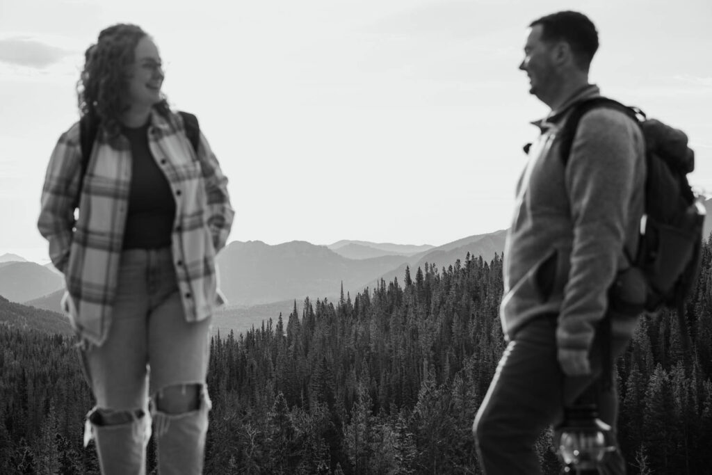 mountains in the distance of a couple hiking up to Emerald lake during their rocky mountain elopement