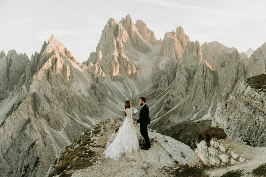A couple shares their vows in front of the mountains during their cadini di misurina elopement in the dolomites
