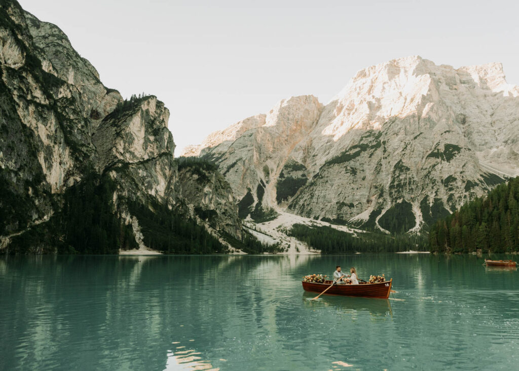 A couple goes for a boat ride during their Lago di Braies elopement in Italy
