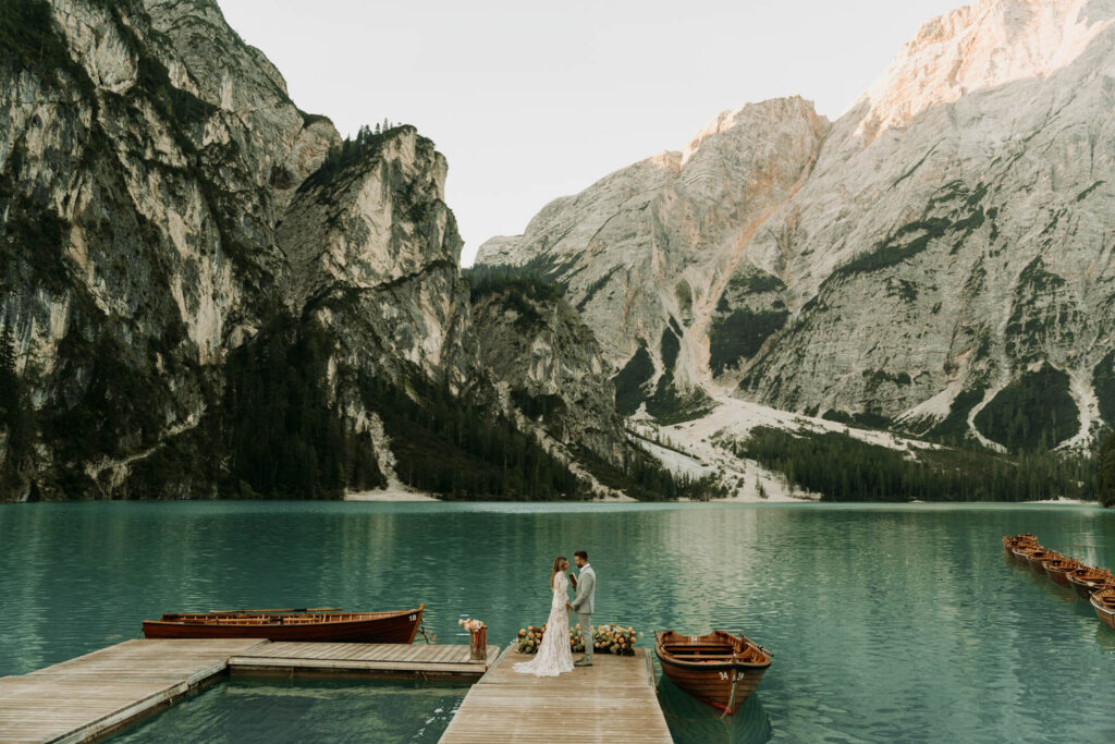 a couple has their ceremony on a private dock at lago di braies for their italian dolomites elopement