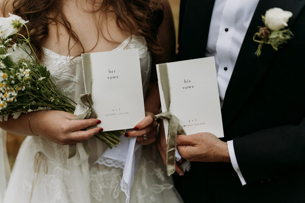 elopement details of a couple holding their vow books